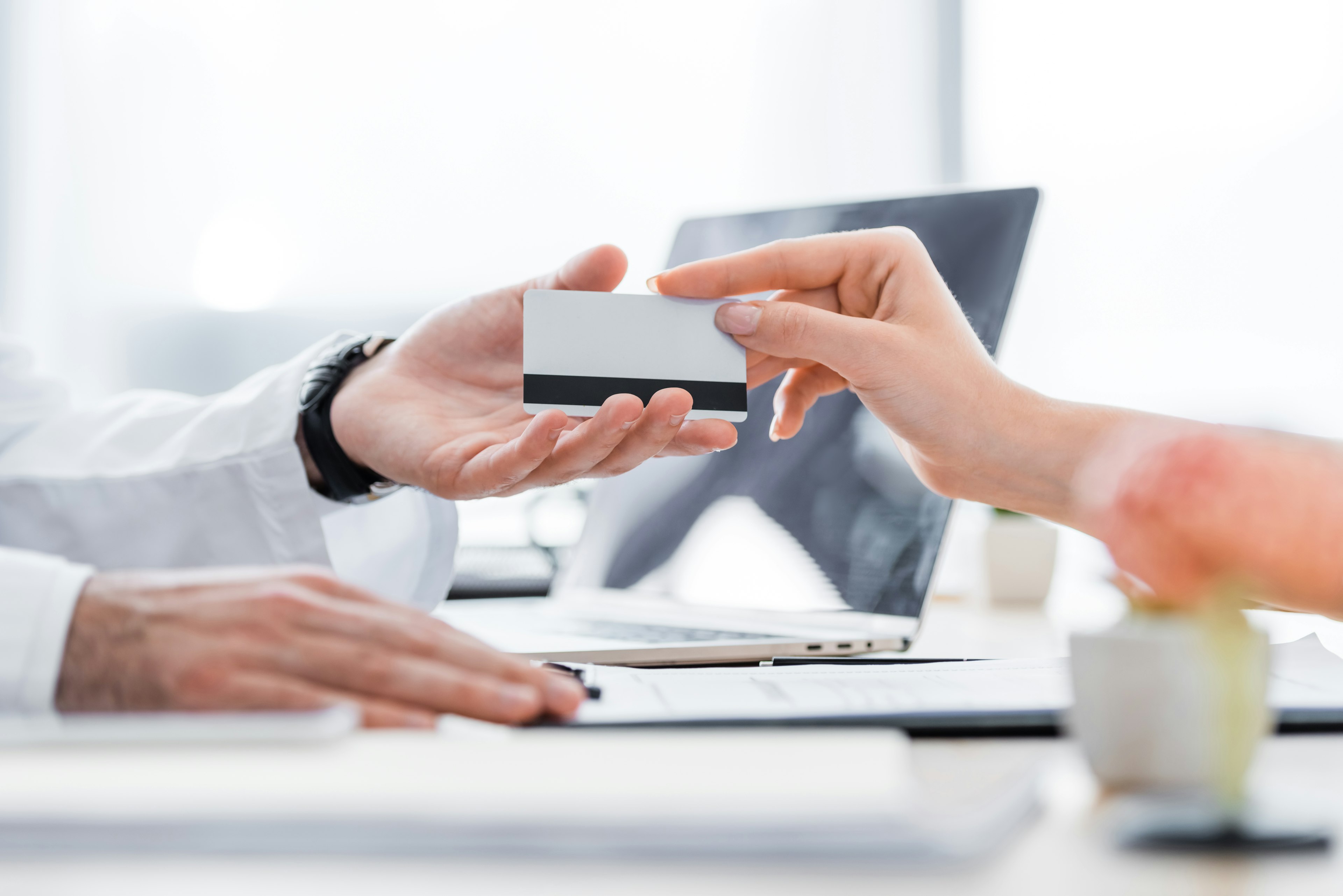 Patient handing credit card to receptionist