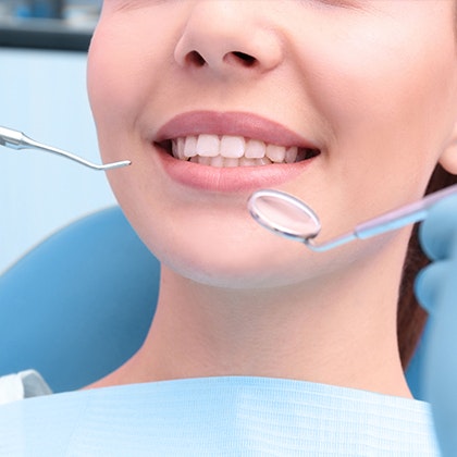 Woman smiling during dental treatment