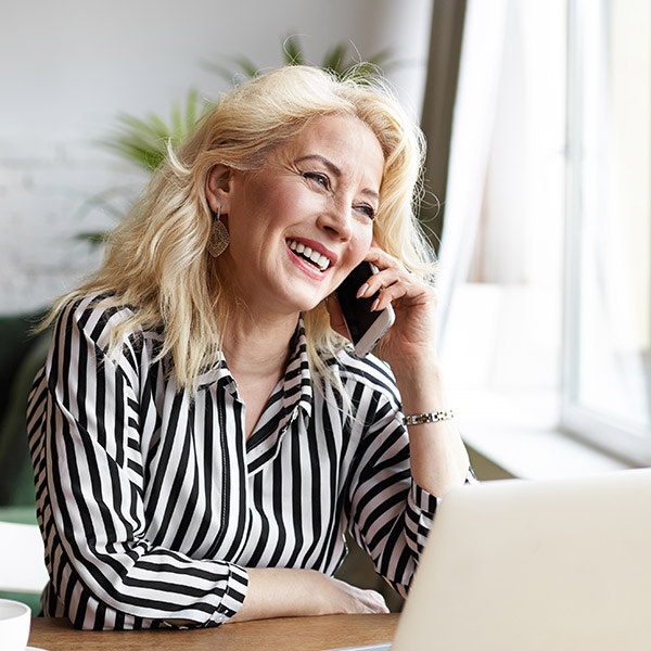 Smiling woman talking on phone