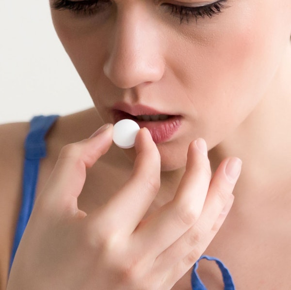 Woman taking sedation pill