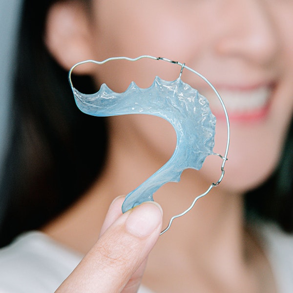 Woman holding retainer