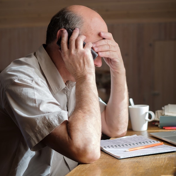 Sad man on the phone