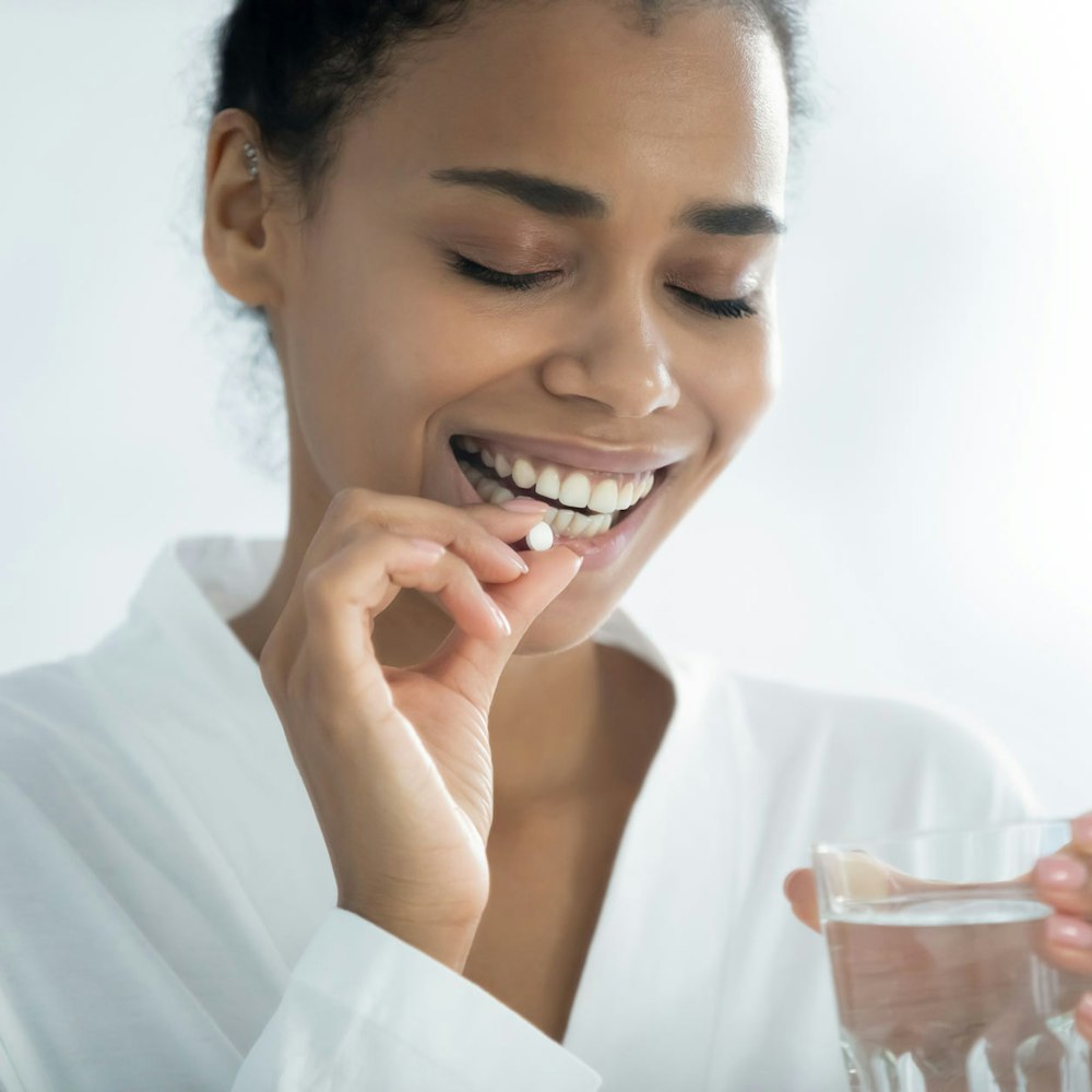 Woman taking oral sedation pill