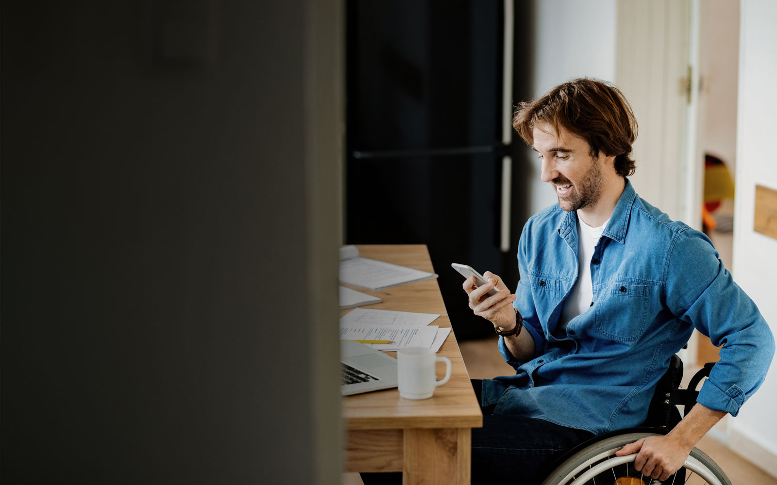man in wheelchair talking on the phone