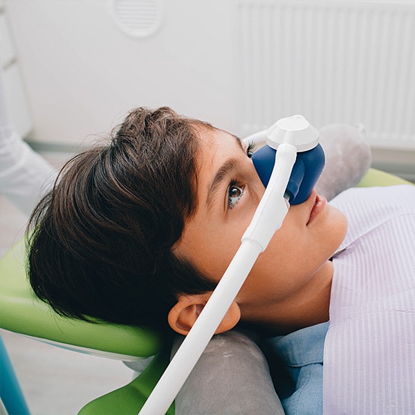 Child in dental chair with nasal mask