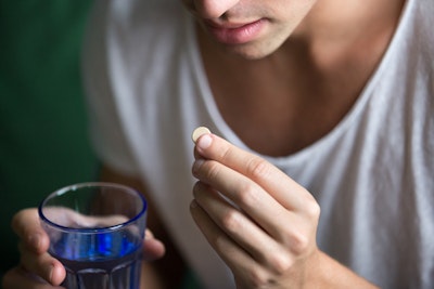 closeup of a hand holding an oral conscious sedation pill