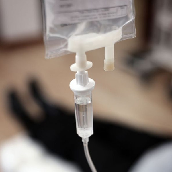 IV with person lying down in the background