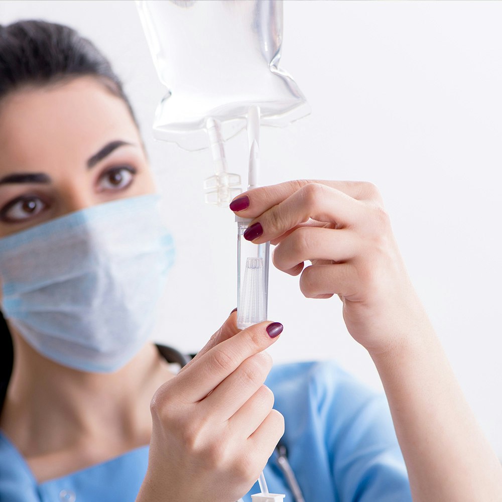 Technician setting up IV drip