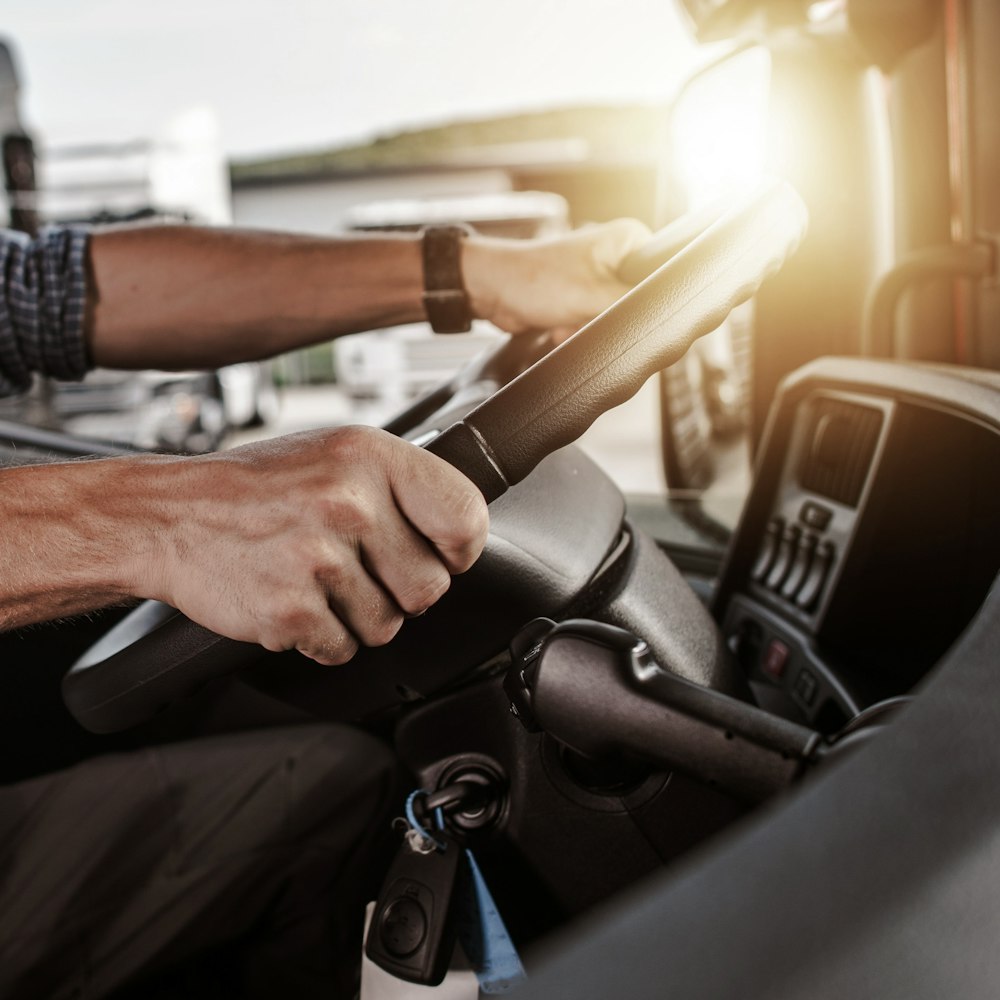 Truck driver's hands on steering wheel