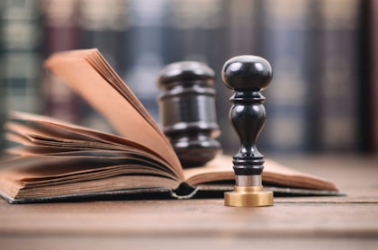 Stamp and gavel on top of book for justice