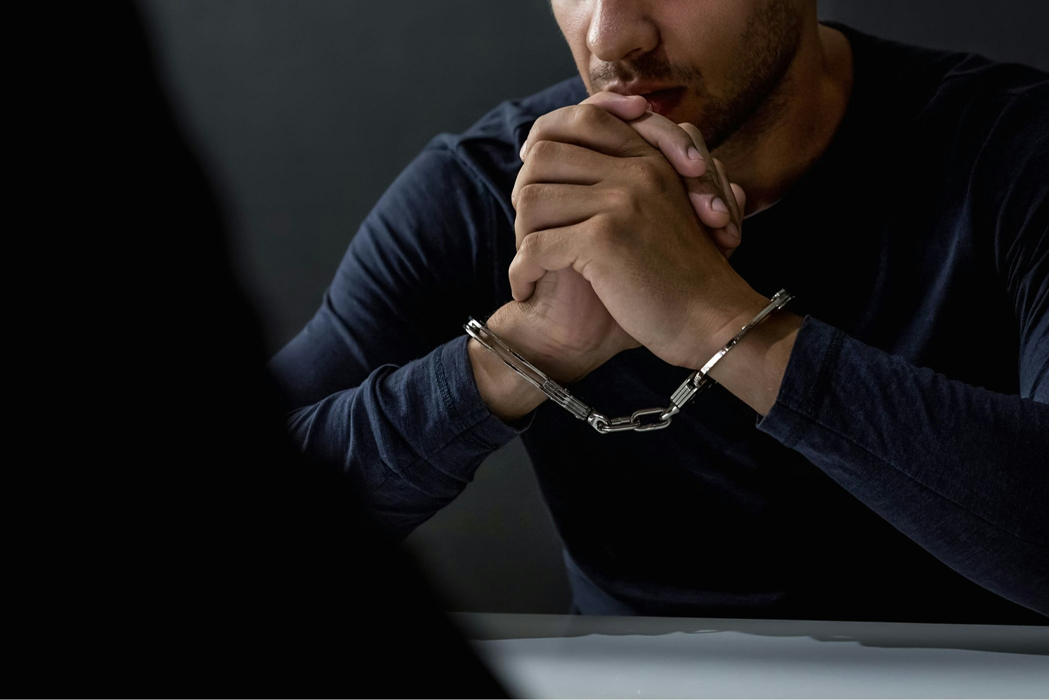 man in handcuffs during interrogation