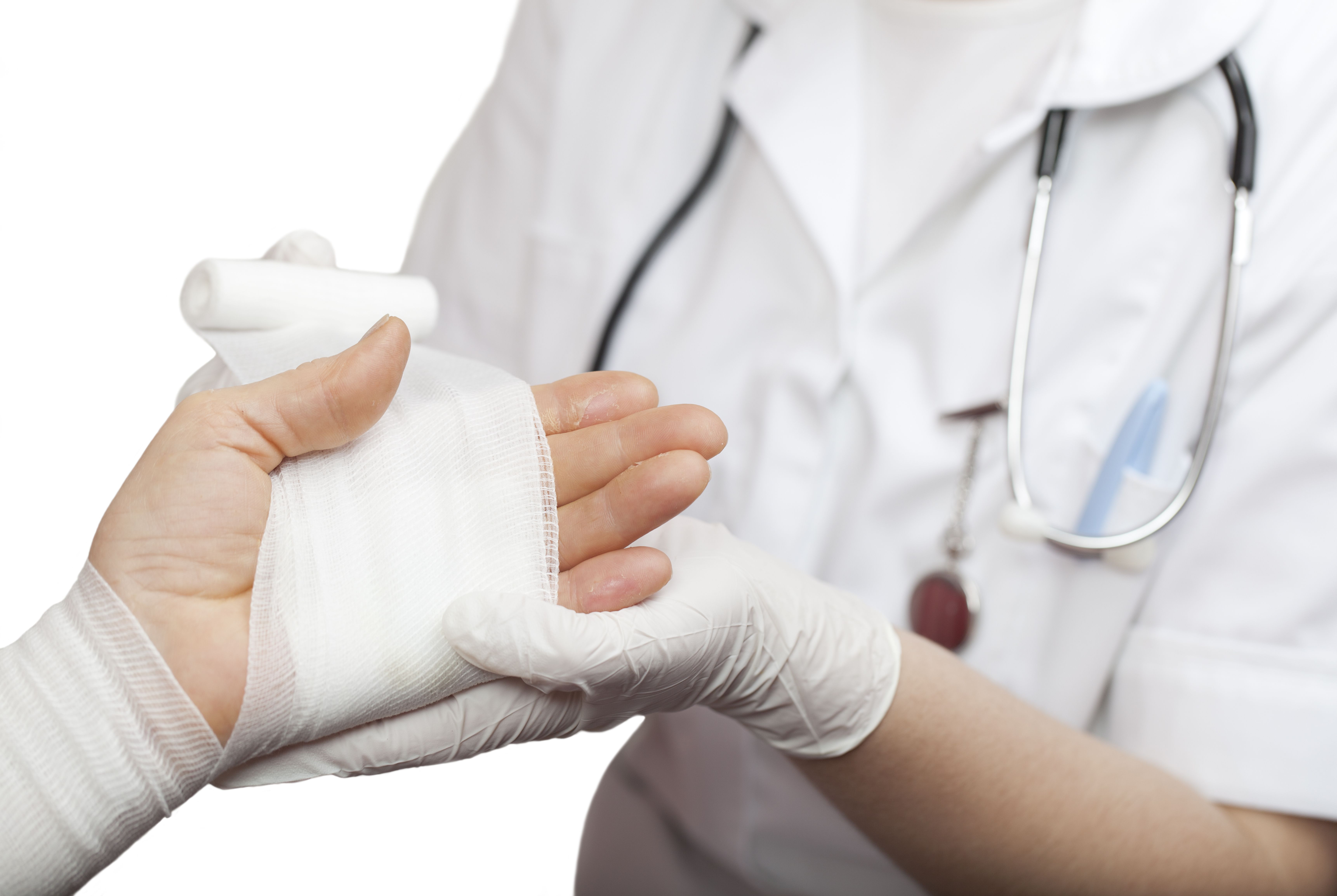 doctor wrapping a patient’s hand with gauze