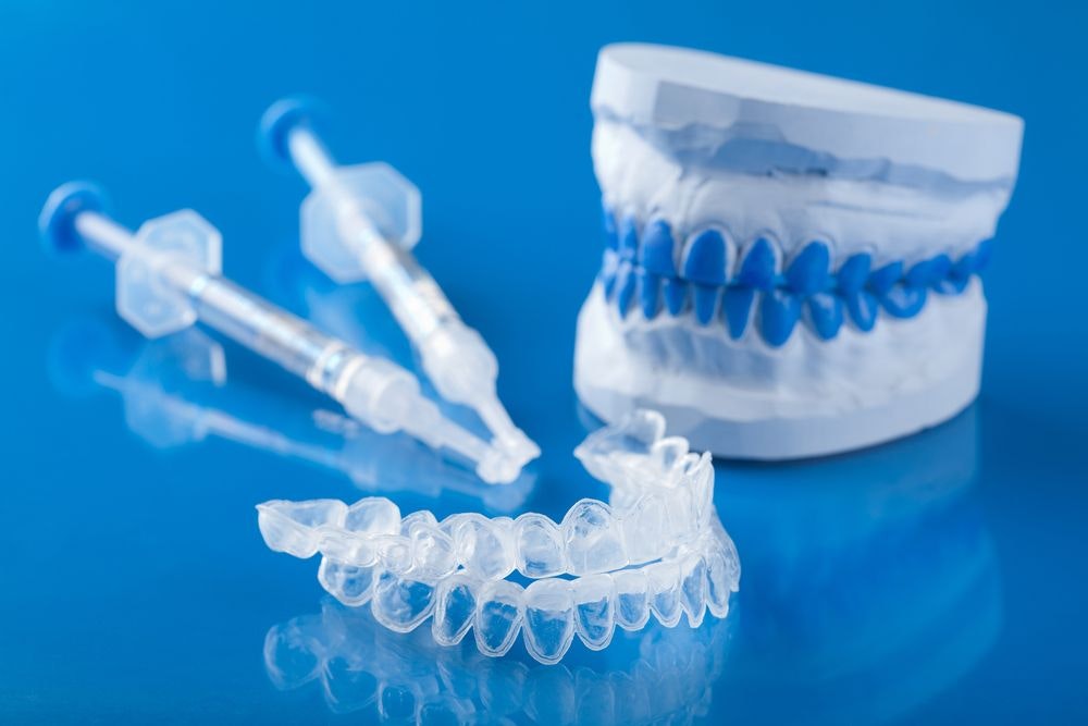 Model of teeth, gel applicator, and clear trays