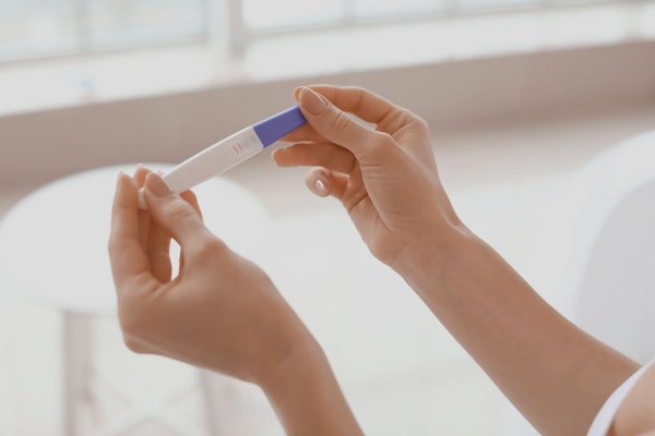 Woman looking at pregnancy test