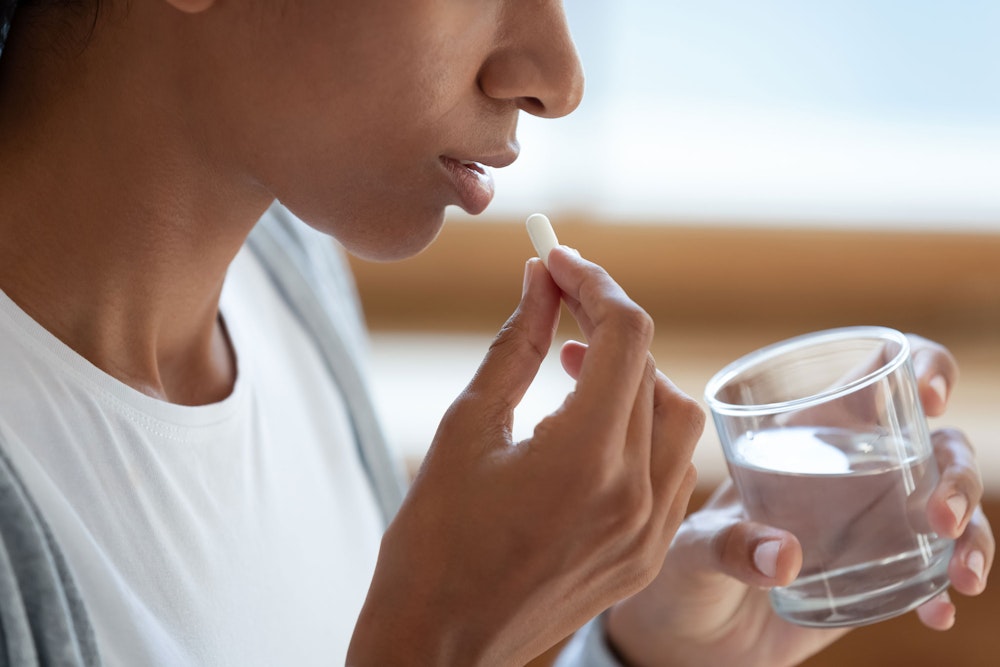 woman taking a pill