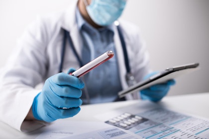 Lab technician looking at blood tests