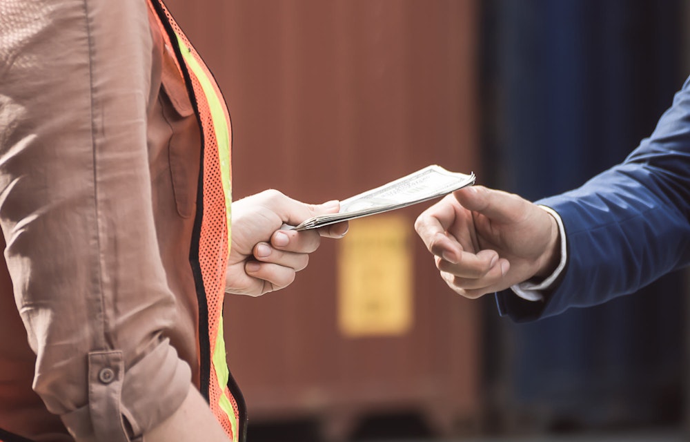 Worker being handed piece of paper