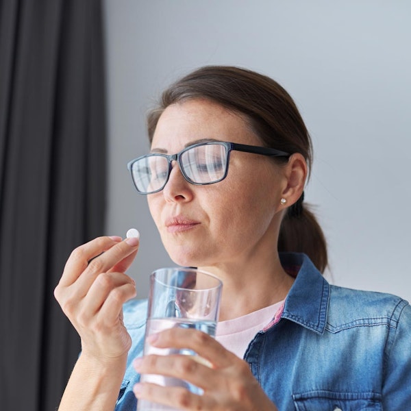woman taking pill