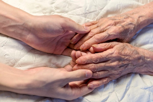 elderly hands being held