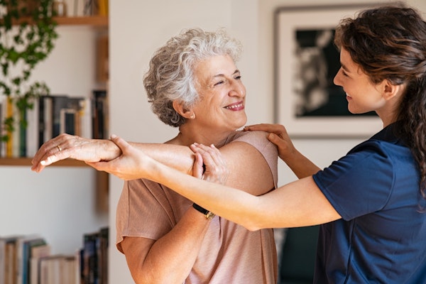 Mature woman exercising with help