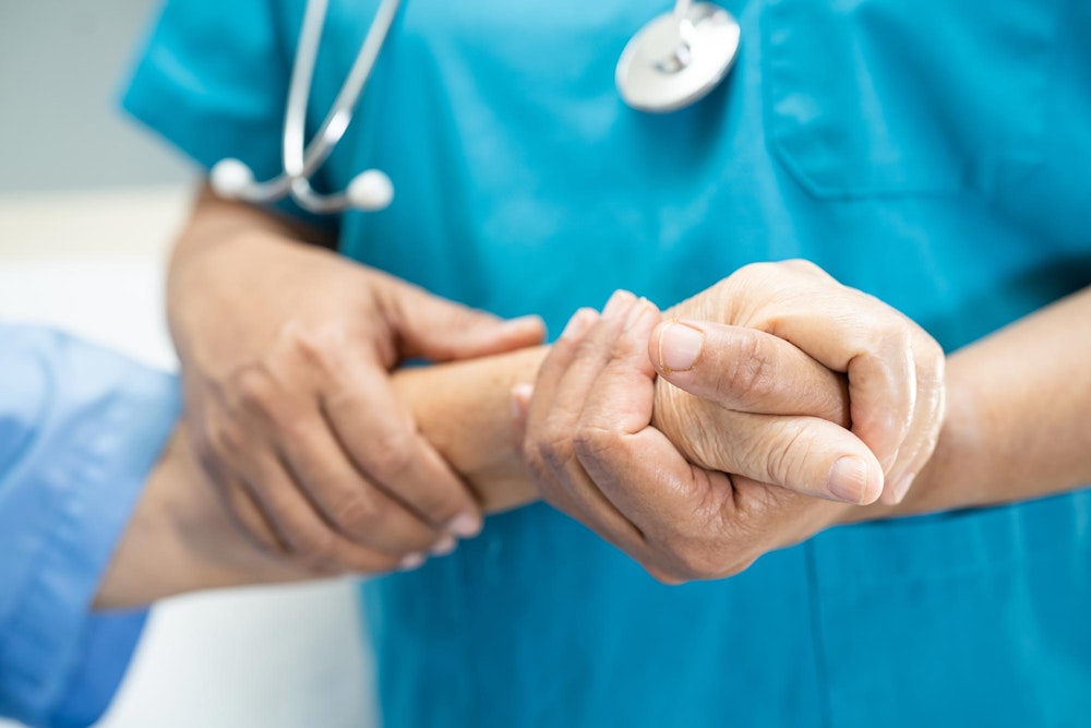 Doctor holding a patient's hand