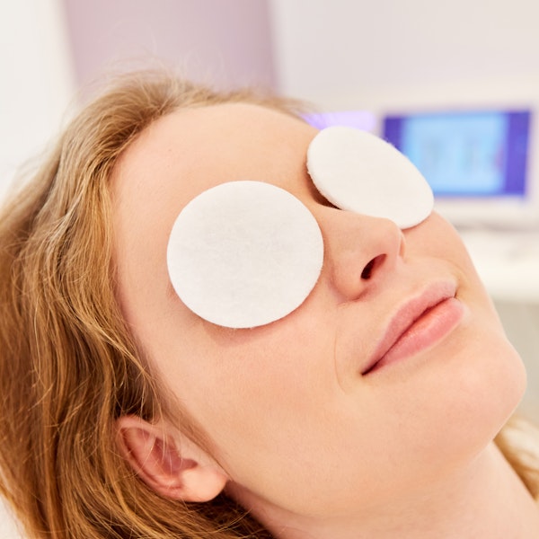 woman with eye compress