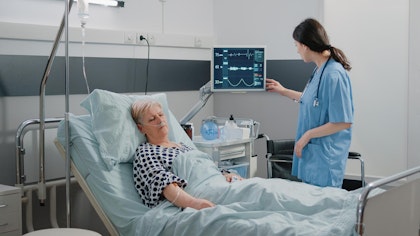 Nurse checking EKG of patient