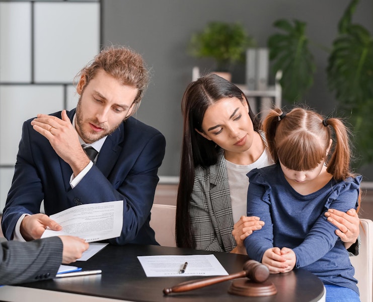 Couple with young daughter meeting with an attorney
