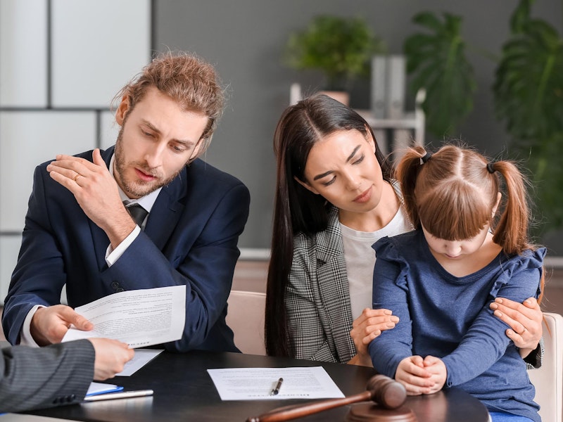 Couple with young daughter meeting with an attorney
