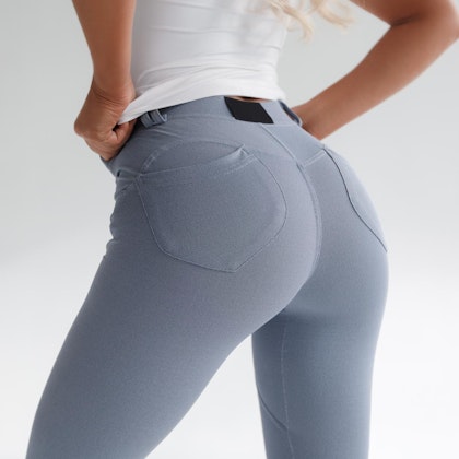 Woman's butt in grey jeans and white t-shirt