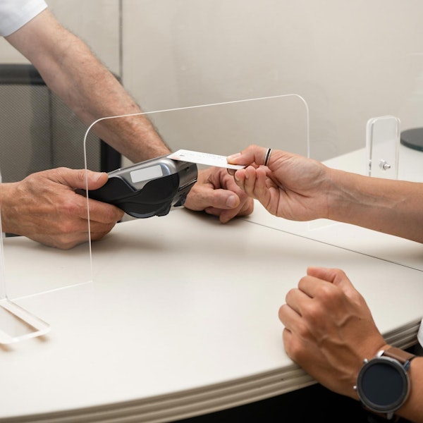 Dental patient handing over credit card to make payment