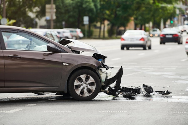 Man holding his neck in pain after getting into a car accident