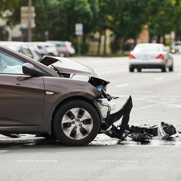 Man holding his neck in pain after getting into a car accident