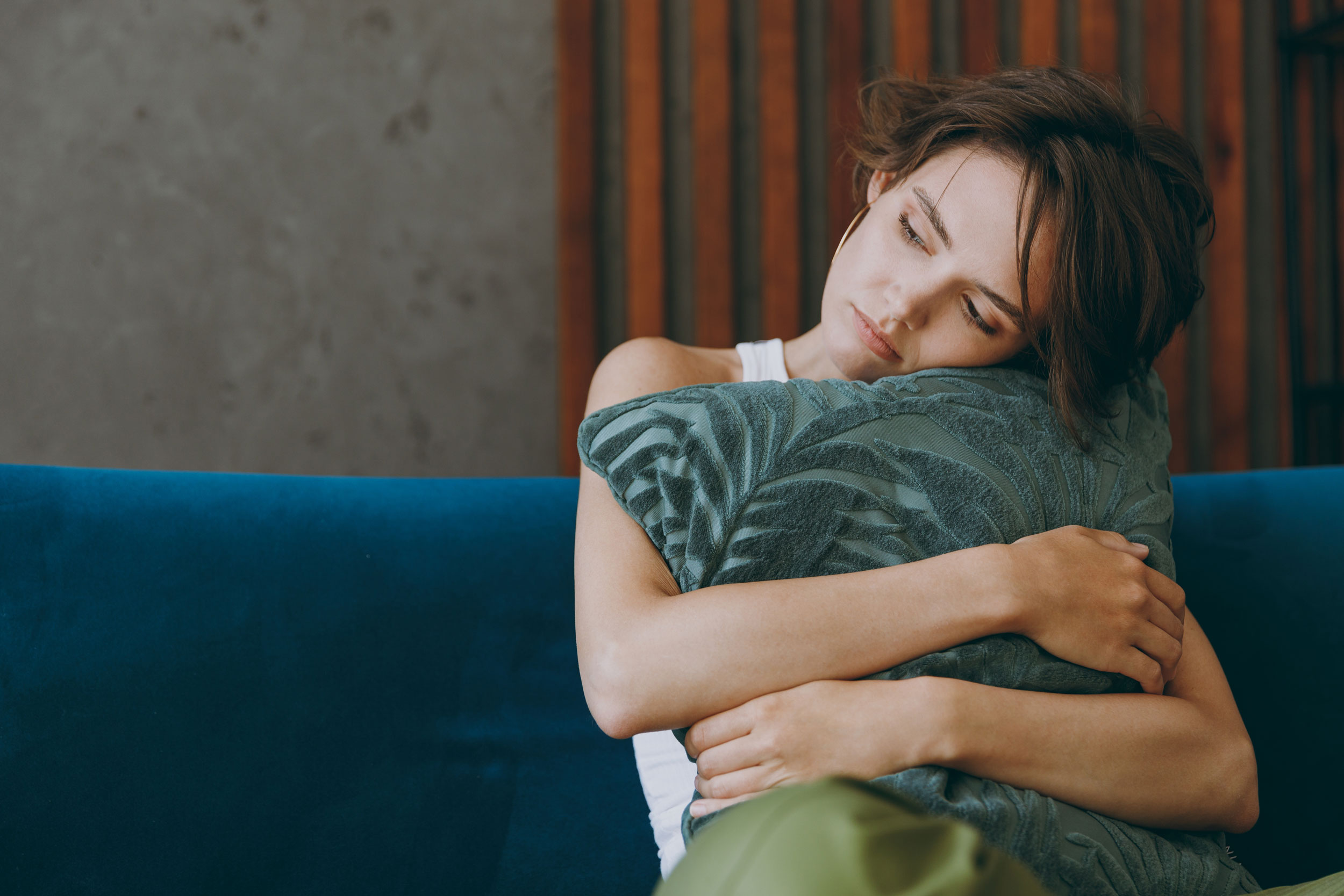 Stressed woman hugging a pillow