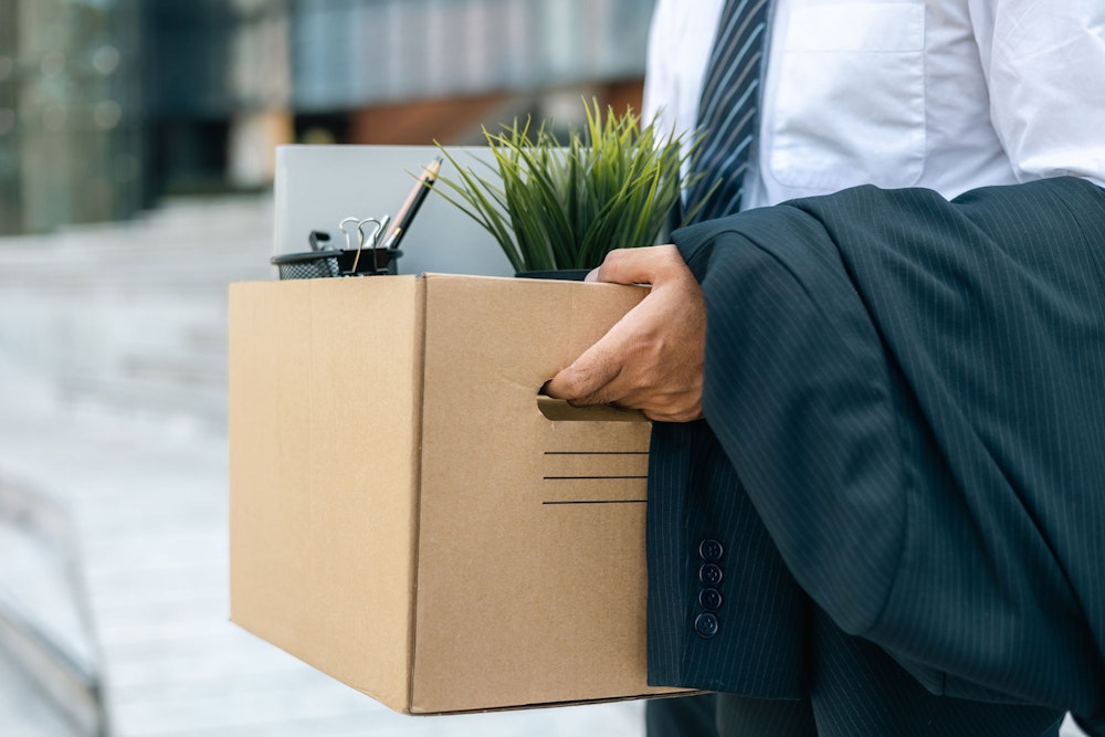 Fired worker with belongings in a box
