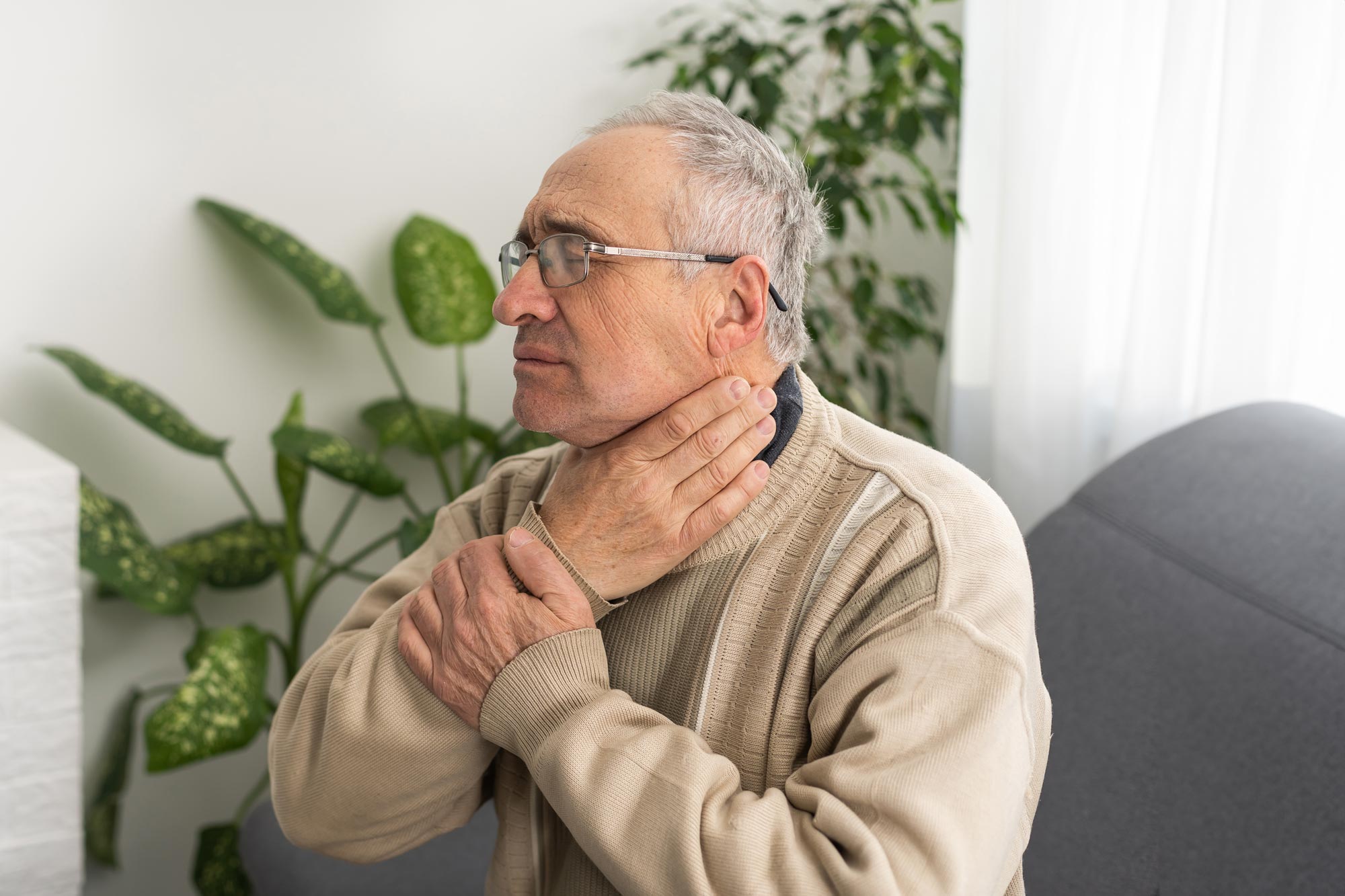 Older man touching face