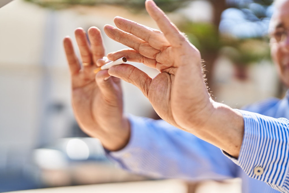 Man breaking cigarette