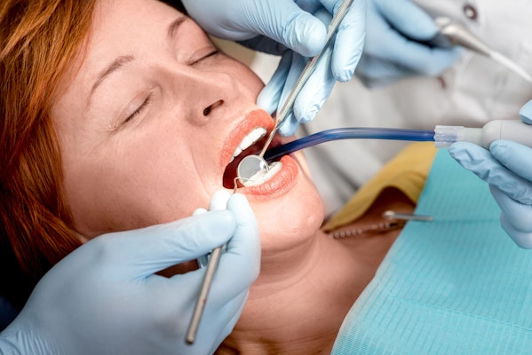 Woman under sedation getting teeth fixed