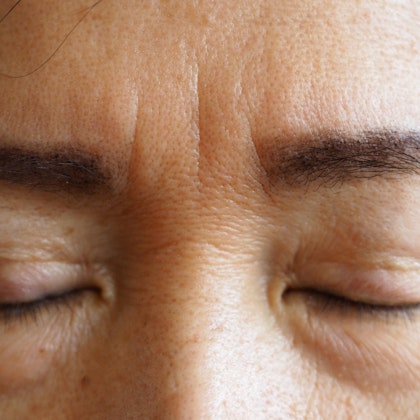 Close up of woman's frown lines