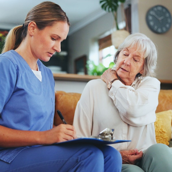 Nursing home resident going over paperwork with a caregiver