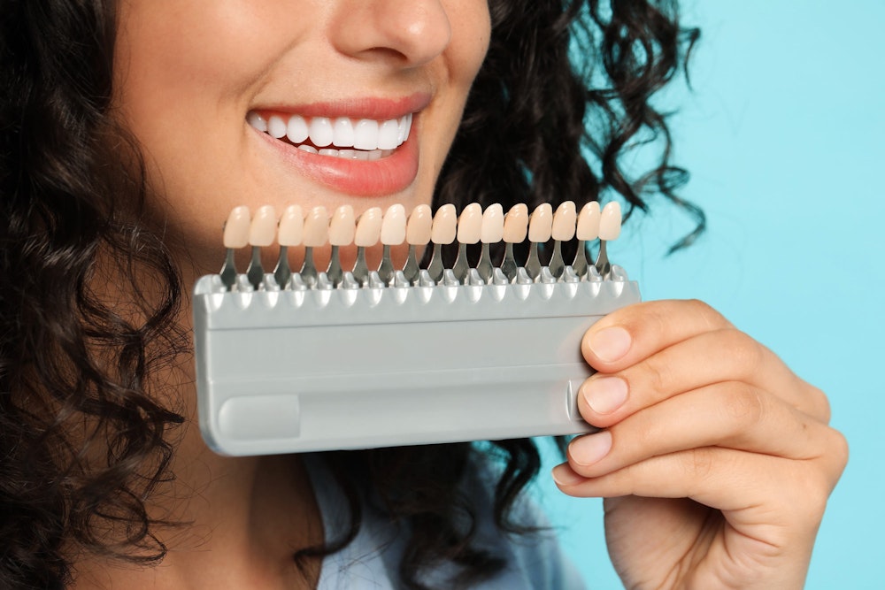 woman comparing veneer shades