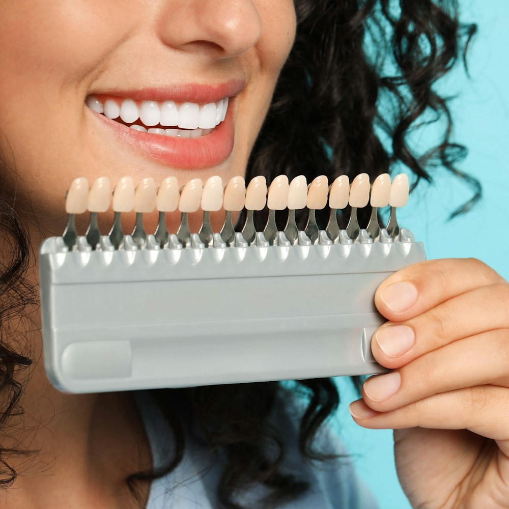 woman comparing veneer shades