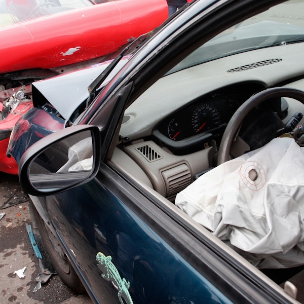 Close up of car accident with air bag deployed