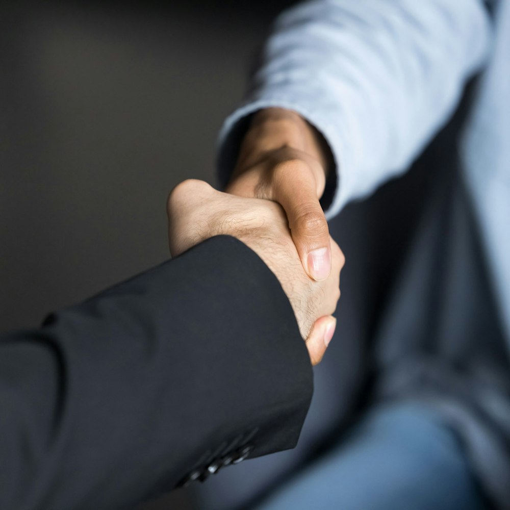 Two people shaking hands in a professional setting