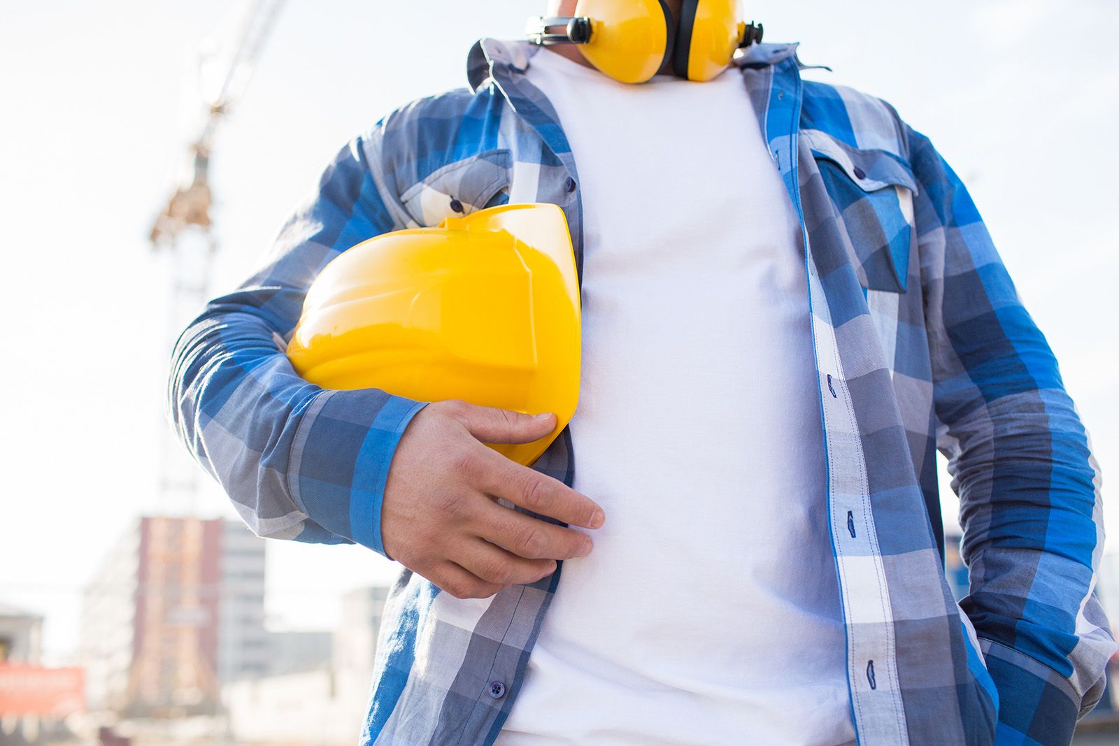 Man holding hard hat under arm