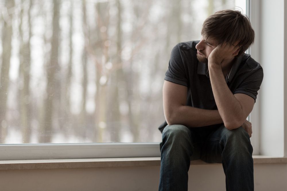 Man staring outside a window
