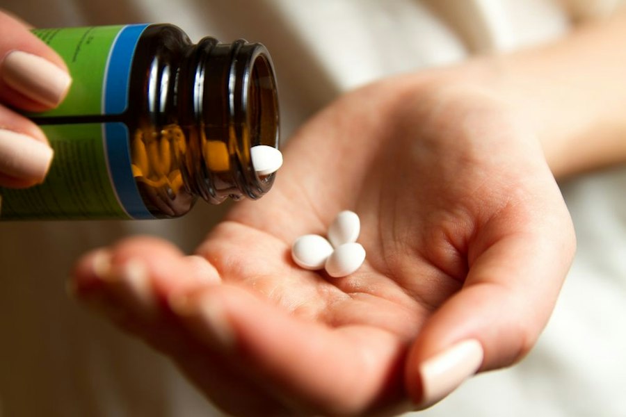 Person with pills in hand