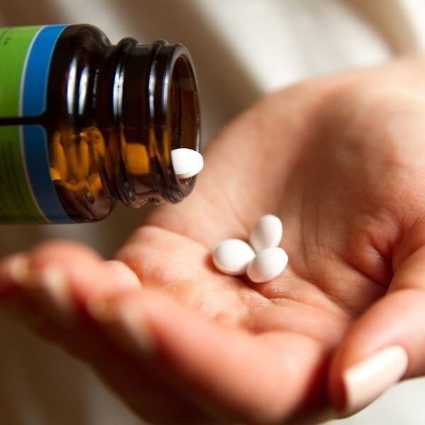 Person with pills in hand