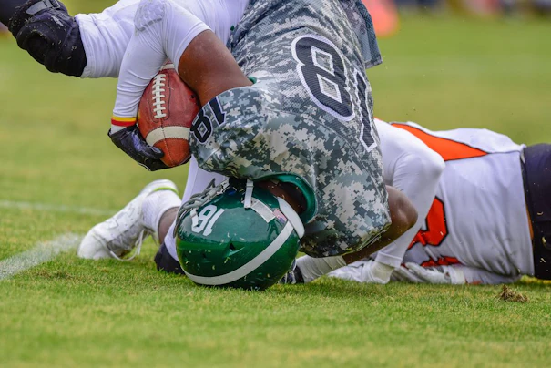 Football player landing on his head.
