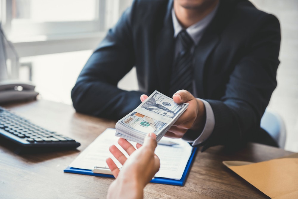 person handing off money